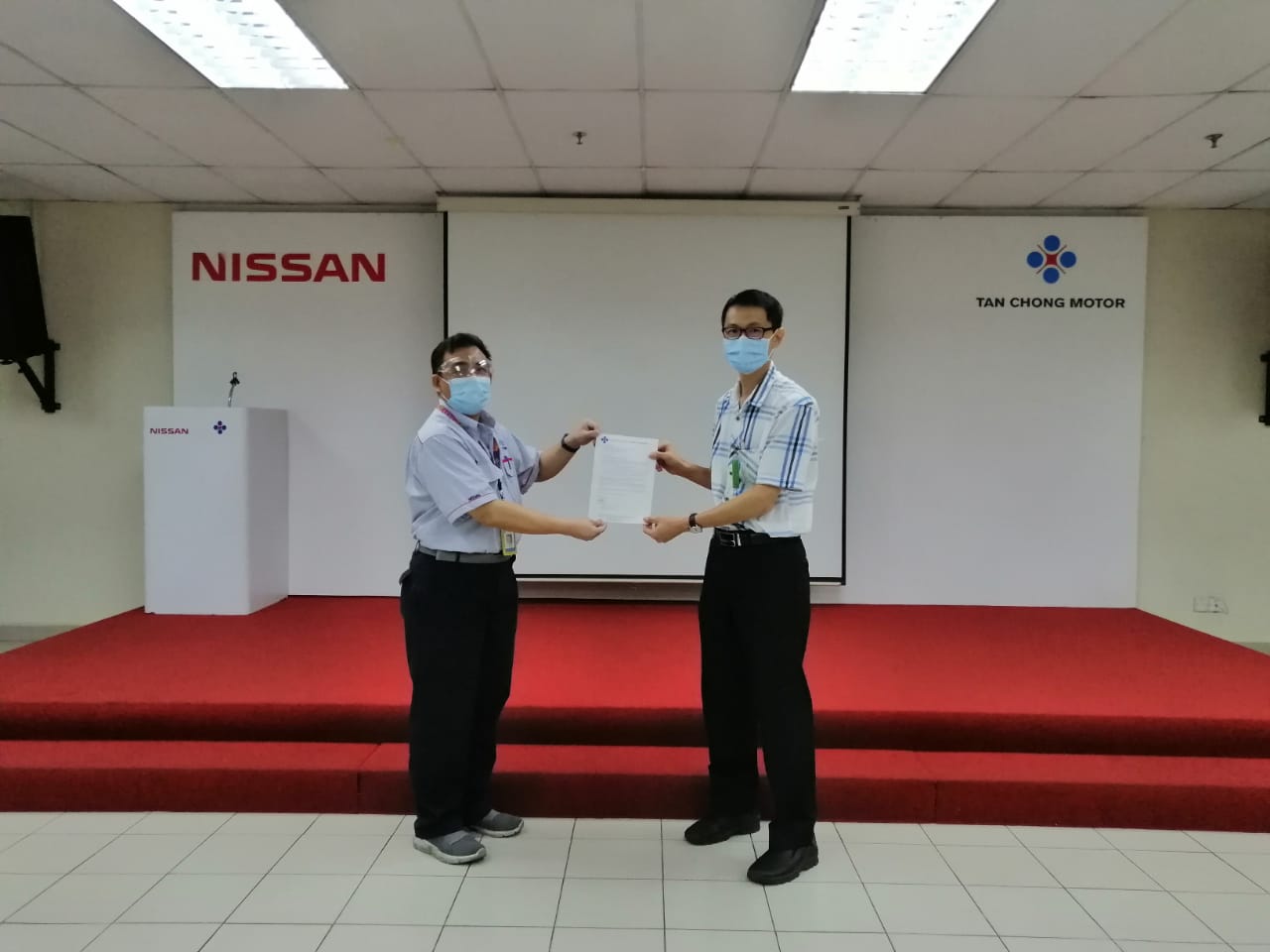 Dr Chua (right) receiving the appointment letter from TCMA Sdn Bhd